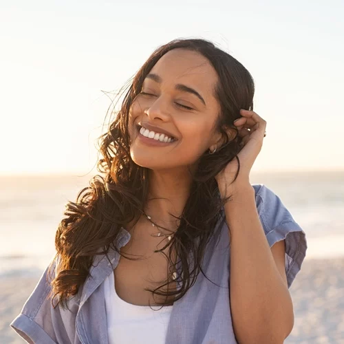 Integrated Health Care Clinic Calgary AB Smiling Woman On Beach